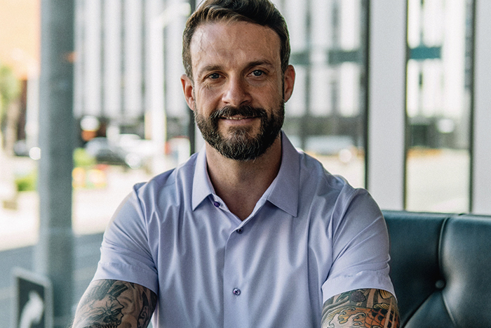 Co-founder of Edmonton’s Central Hall Social, Jesse, smiling at the camera.