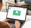 Woman on her laptop checking her emails with a new message in her inbox.